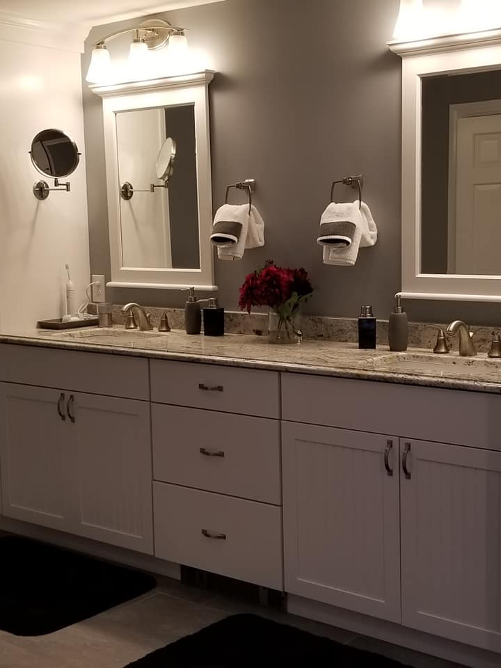 White double vanity installation in bathroom remodel