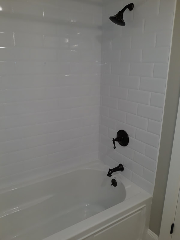 Shower. close up with white subway tile and black fixtures